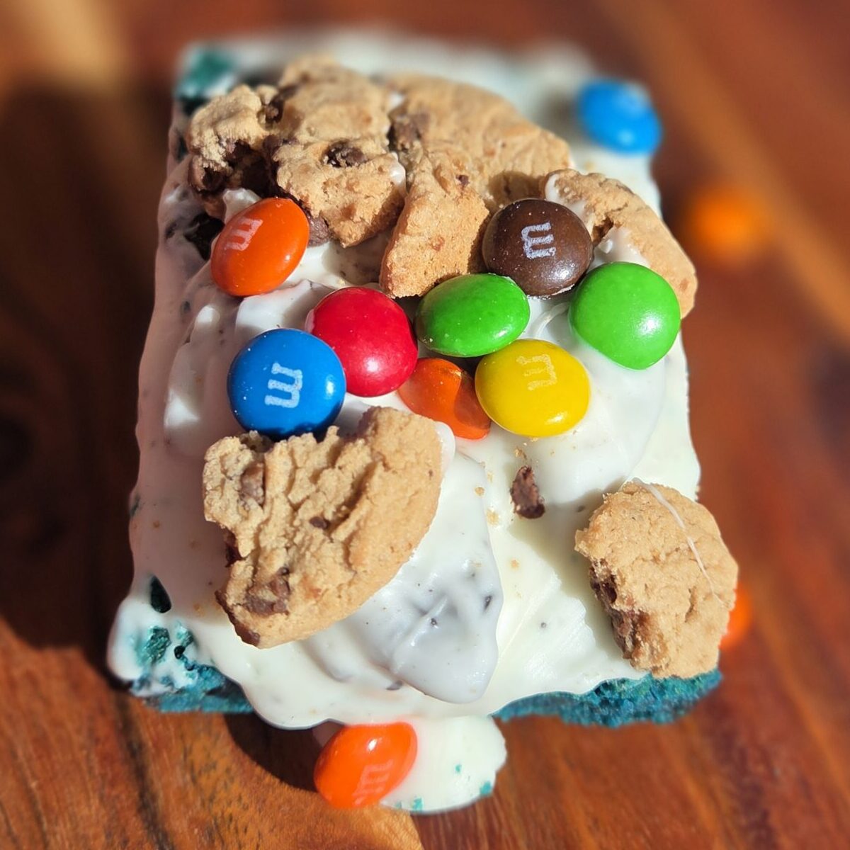 Blue velvet loaded cookie with M&Ms, Chips Ahoy and white chocolate drizzle — Rainbow Cookies and Fudge, Pompano Beach FL